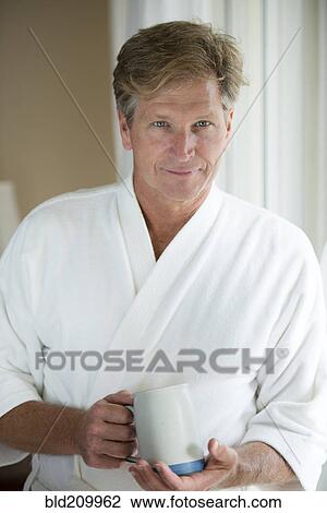 Caucasian man having coffee in bathrobe View Large Photo Image Stock Image - Caucasian man having coffee in bathrobe. Fotosearch