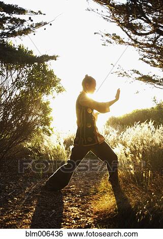 Caucasian man practicing tai-chi in remote area View Large Photo Image Stock Photograph - Caucasian man practicing tai-chi in remote area. Fotosearch