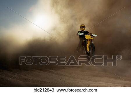Caucasian man riding dirt bike in dust cloud View Large Photo Image Stock Image - Caucasian man riding dirt bike in dust cloud. Fotosearch