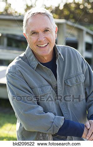 Stock Image - Caucasian man smiling outdoors. Fotosearch