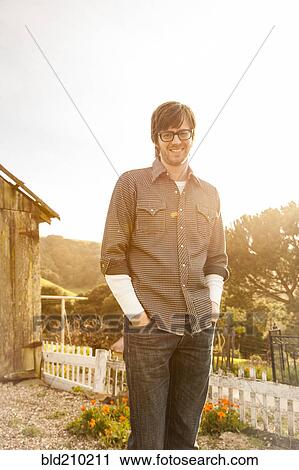 Stock Image - Caucasian man smiling outdoors. Fotosearch