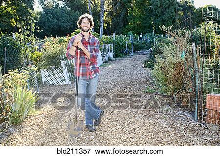 Stock Photo - Caucasian man standing in garden. Fotosearch