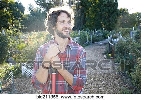 Caucasian man standing in garden View Large Photo Image Stock Photograph - Caucasian man standing in garden. Fotosearch