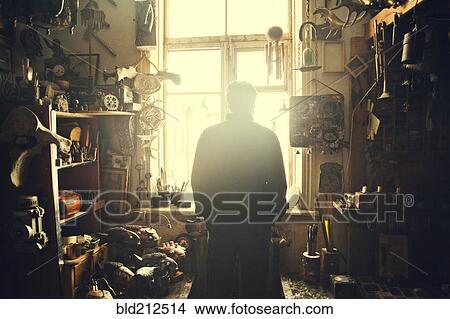 Picture - Caucasian man standing in workshop. Fotosearch