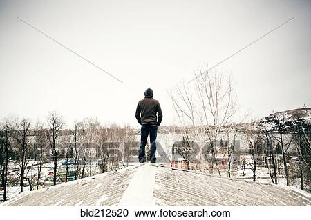 Caucasian man standing on snowy roof View Large Photo Image Stock Image - Caucasian man standing on snowy roof. Fotosearch