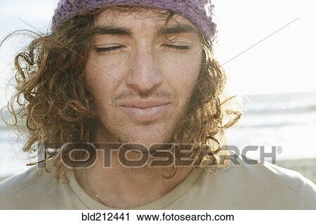 Caucasian man with eyes closed on beach View Large Photo Image Stock Image - Caucasian man with eyes closed on beach. Fotosearch