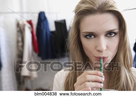 Caucasian model sipping drink in dressing room View Large Photo Image Stock Photo - Caucasian model sipping drink in dressing room. Fotosearch