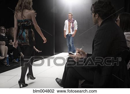 Stock Image - Caucasian models on runway in fashion show. Fotosearch