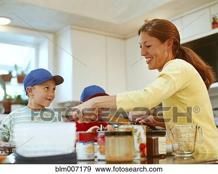 Caucasian mother and sons preparing food View Large Photo Image Stock Photo - Caucasian mother and sons preparing food. Fotosearch