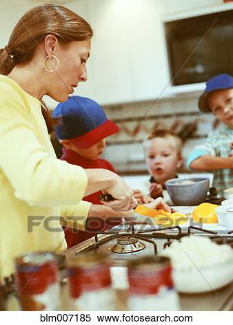Caucasian mother and sons preparing food View Large Photo Image Stock Photography - Caucasian mother and sons preparing food. Fotosearch