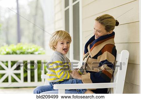 Stock Photo - Caucasian mother holding son. Fotosearch
