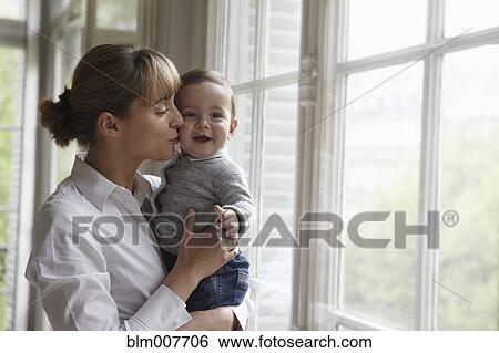 Caucasian mother kissing baby View Large Photo Image Stock Photograph - Caucasian mother kissing baby. Fotosearch