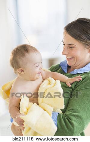 Caucasian mother toweling baby girl with Down Syndrome View Large Photo Image Stock Photo - Caucasian mother toweling baby girl with Down Syndrome. Fotosearch
