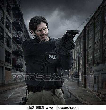 Stock Photography - Caucasian policeman aiming gun on city street. Fotosearch