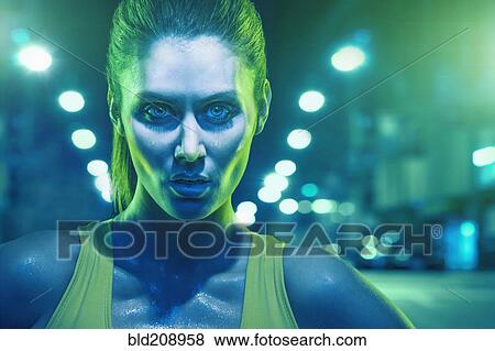 Stock Photo - Caucasian runner standing on city street. Fotosearch