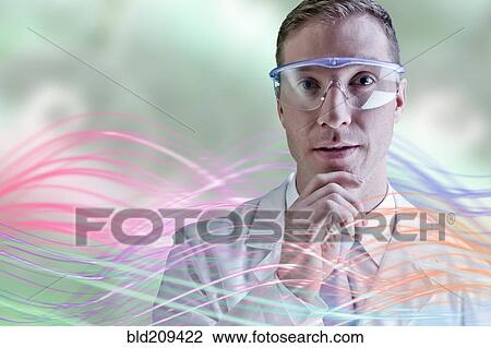 Stock Image - Caucasian scientist wearing safety goggles. Fotosearch