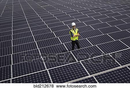 Caucasian technician smiling on solar panels View Large Photo Image Stock Photo - Caucasian technician smiling on solar panels. Fotosearch