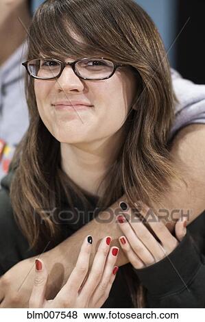 Caucasian teenage girl hugging friend View Large Photo Image Stock Photo - Caucasian teenage girl hugging friend. Fotosearch