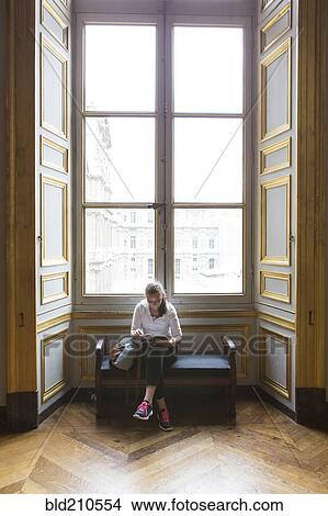 Caucasian teenage girl studying in ornate window at Louvre Museum, Paris, Ile De France, France View Large Photo Image Picture - Caucasian teenage girl studying in ornate window at Louvre Museum, Paris, Ile De France, France. Fotosearch