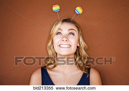Stock Photography - Caucasian teenage girl wearing novelty antenna. Fotosearch