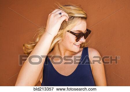 Stock Photo - Caucasian teenage girl wearing sunglasses. Fotosearch