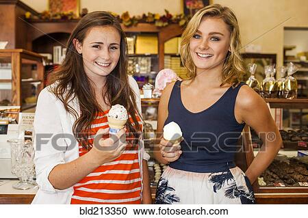 Caucasian teenage girls eating ice cream in candy shop View Large Photo Image Stock Image - Caucasian teenage girls eating ice cream in candy shop. Fotosearch