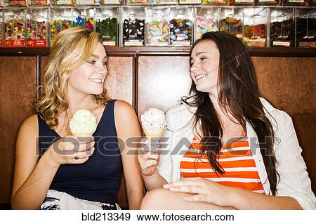 Caucasian teenage girls eating ice cream cones View Large Photo Image Stock Photo - Caucasian teenage girls eating ice cream cones. Fotosearch