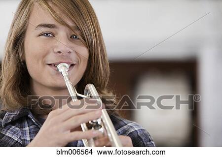 Picture - Caucasian teenager playing trumpet. Fotosearch
