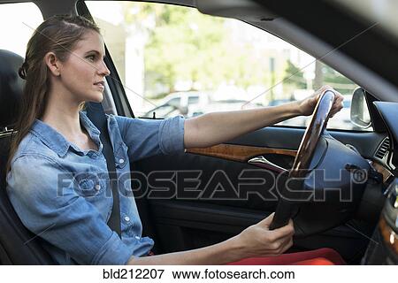 Stock Photo - Caucasian woman driving car. Fotosearch