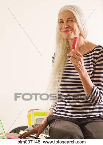 Stock Photograph - Caucasian woman enjoying popsicle. Fotosearch