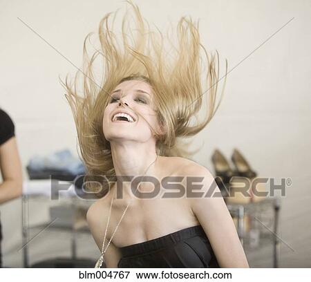 Stock Photo - Caucasian woman flipping her hair. Fotosearch