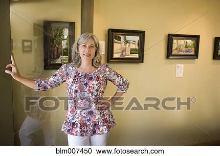 Caucasian woman leaning on doorway View Large Photo Image Stock Image - Caucasian woman leaning on doorway. Fotosearch
