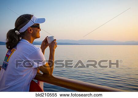 Caucasian woman overlooking ocean from boat deck View Large Photo Image Stock Photography - Caucasian woman overlooking ocean from boat deck. Fotosearch