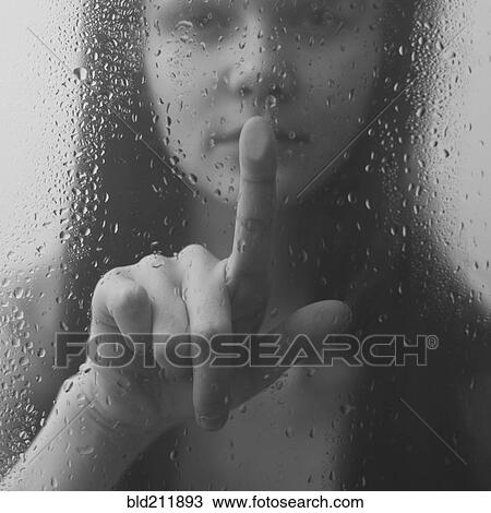 Stock Image - Caucasian woman pressing wet glass. Fotosearch