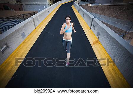 Caucasian woman running on city street View Large Photo Image Picture - Caucasian woman running on city street. Fotosearch