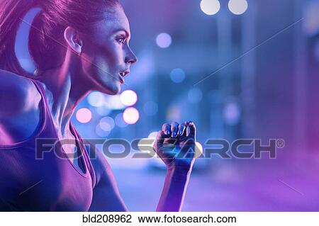Stock Image - Caucasian woman running on city street. Fotosearch