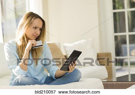 Caucasian woman shopping online with digital tablet View Large Photo Image Stock Photo - Caucasian woman shopping online with digital tablet. Fotosearch