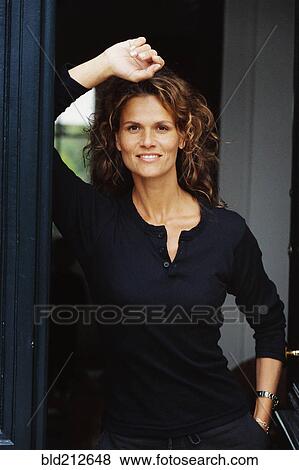 Stock Photo - Caucasian woman smiling in doorway. Fotosearch