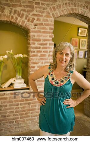 Caucasian woman standing with hands on hips View Large Photo Image Stock Image - Caucasian woman standing with hands on hips. Fotosearch