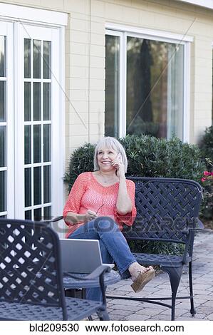 Stock Image - Caucasian woman talking on cell phone. Fotosearch