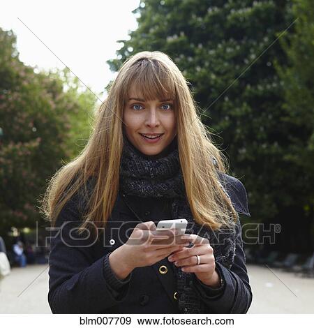 Caucasian woman text messaging on cell phone View Large Photo Image Stock Photo - Caucasian woman text messaging on cell phone. Fotosearch