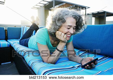 Caucasian woman using cell phone on urban rooftop View Large Photo Image Stock Image - Caucasian woman using cell phone on urban rooftop. Fotosearch