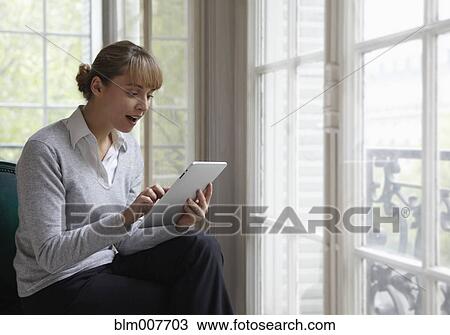 Caucasian woman using digital tablet View Large Photo Image Stock Image - Caucasian woman using digital tablet. Fotosearch