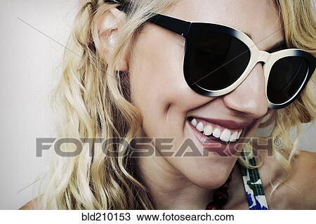 Stock Image - Caucasian woman wearing sunglasses. Fotosearch
