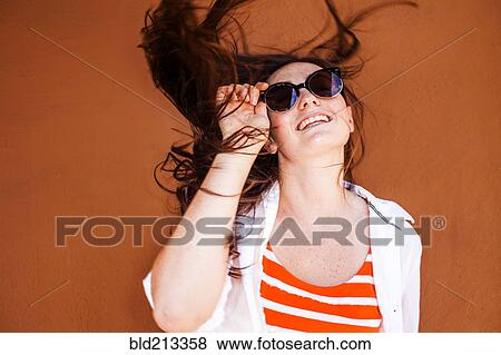 Stock Photo - Caucasian woman wearing sunglasses. Fotosearch