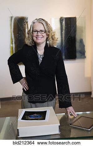 Caucasian woman working in art gallery View Large Photo Image Picture - Caucasian woman working in art gallery. Fotosearch