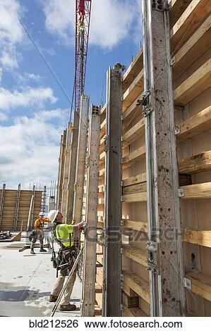 Stock Photograph - Caucasian workers at construction site. Fotosearch