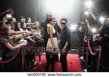 Stock Image - Celebrities arriving on red carpet. Fotosearch