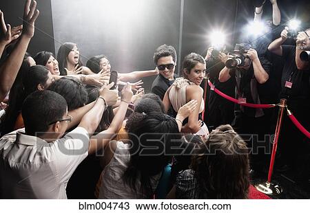 Stock Image - Celebrities posing on red carpet. Fotosearch