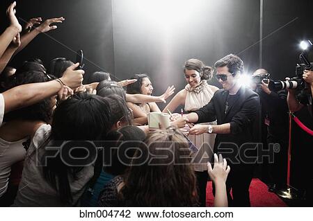 Celebrities signing autographs on red carpet View Large Photo Image Stock Image - Celebrities signing autographs on red carpet. Fotosearch